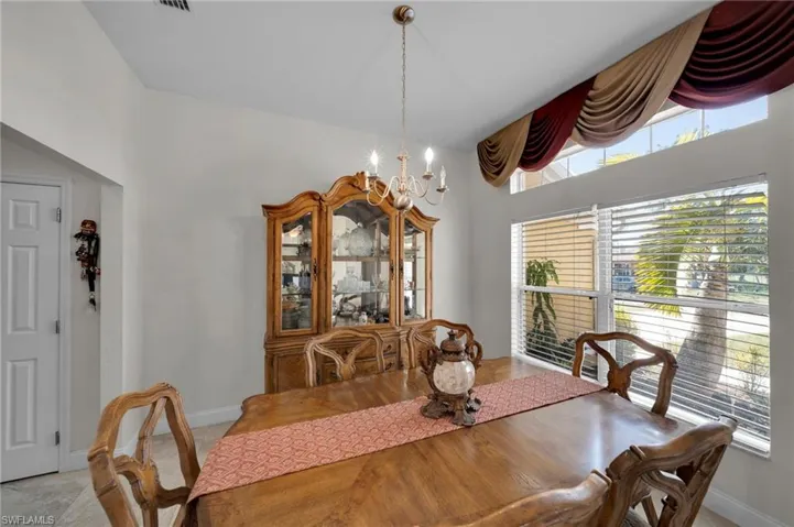 Dining area featuring baseboards and an inviting chandelier