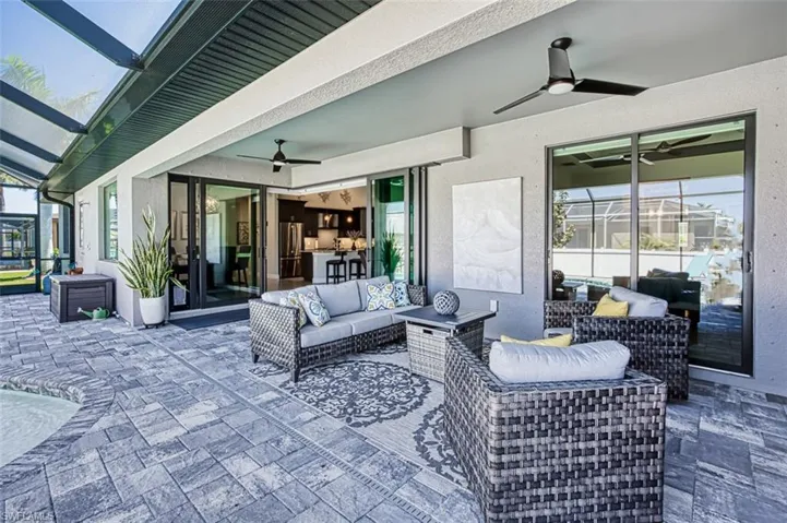 View of terrace with ceiling fan and an outdoor living space. Plumbing and electric ready for outdoor kitchen under the tv.