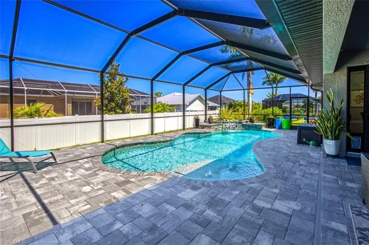 View of pool featuring a patio, pool water feature, and a lanai