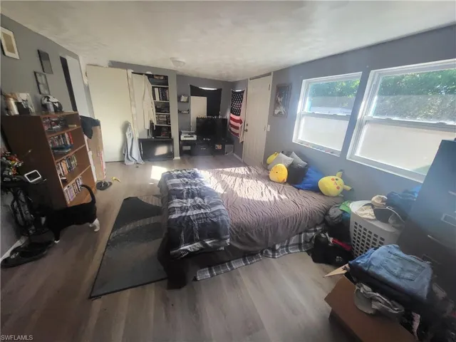 Bedroom with hardwood / wood-style flooring