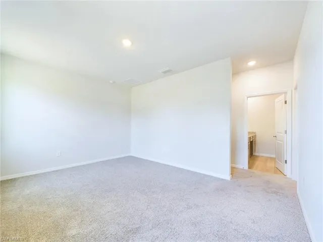 Spare room with light colored carpet