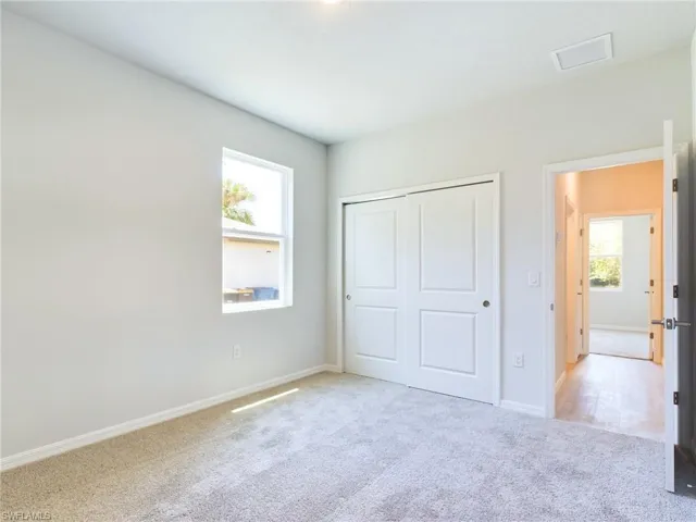 Unfurnished bedroom with carpet floors and a closet
