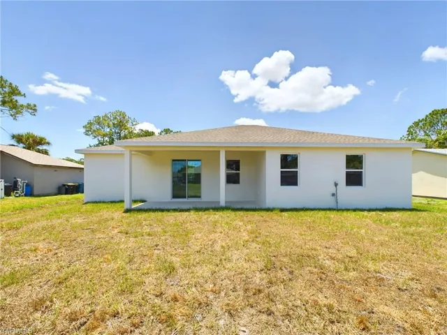 Back of property with a patio and a yard