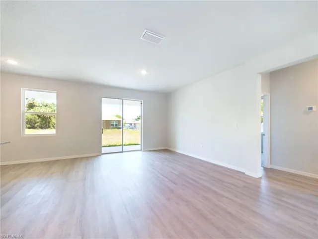 Unfurnished room with plenty of natural light and light hardwood / wood-style floors