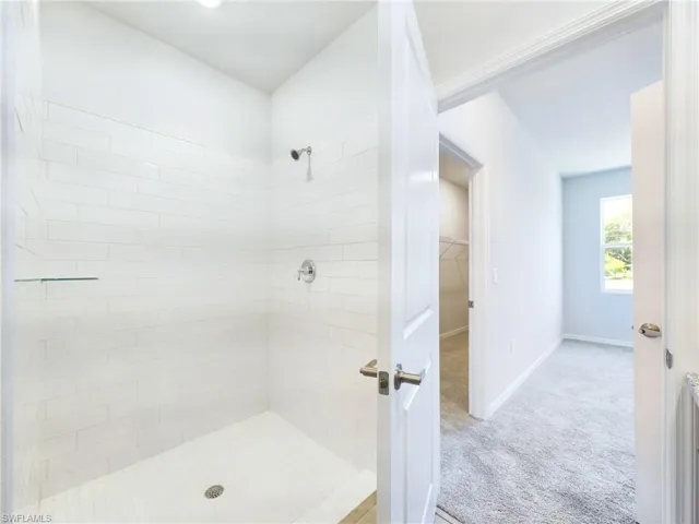 Bathroom featuring tiled shower