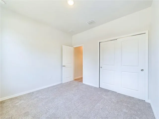 Unfurnished bedroom with carpet floors and a closet