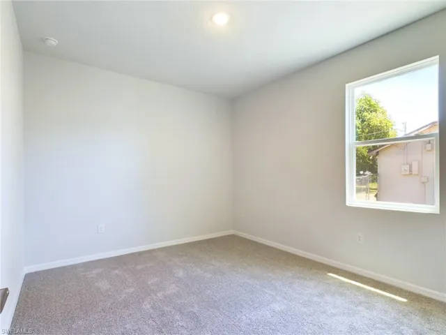 Empty room with plenty of natural light and carpet flooring