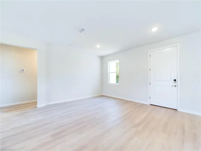 Unfurnished room with light hardwood / wood-style flooring