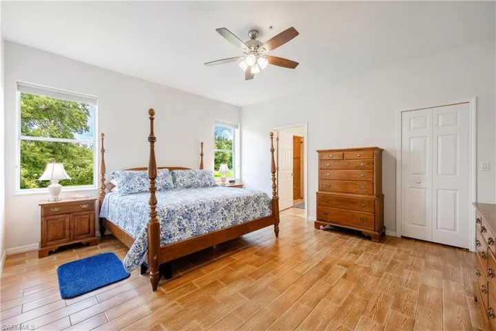 Bedroom featuring light wood-type flooring, a closet, and ceiling fan