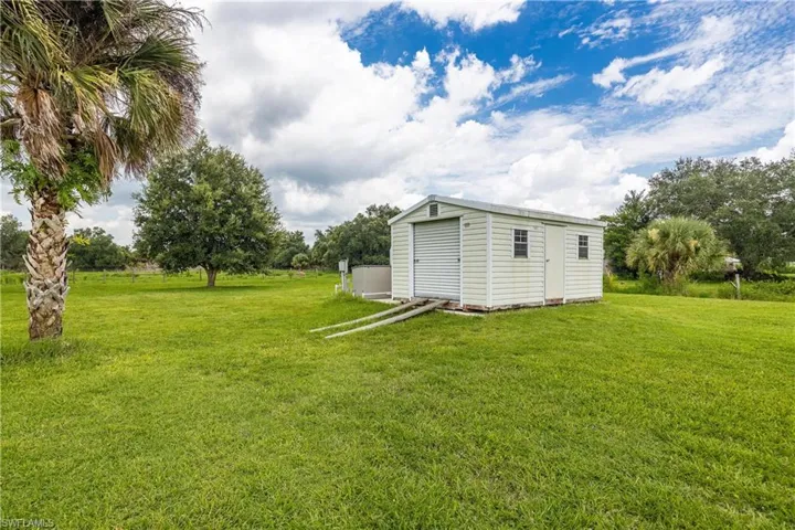 View of yard featuring a storage unit