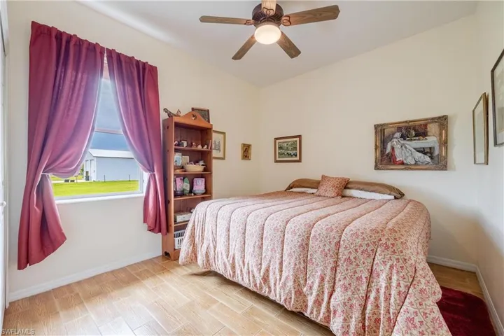 Bedroom featuring ceiling fan and light hardwood / wood-style floors
