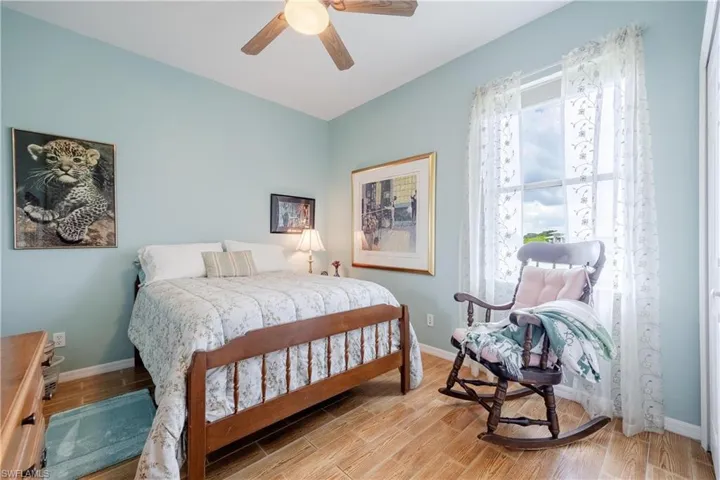 Bedroom with ceiling fan and wood-type flooring