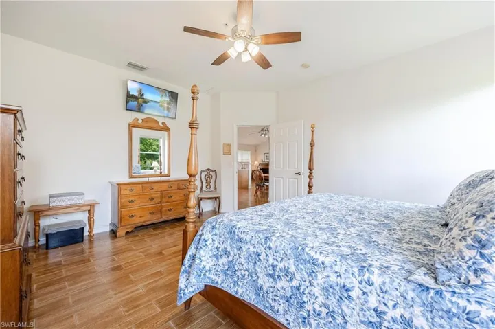 Bedroom with hardwood / wood-style floors and ceiling fan