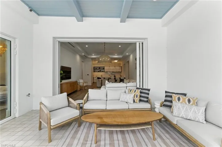 Living room with recessed lighting, a chandelier, and a wooden ceiling with exposed beams