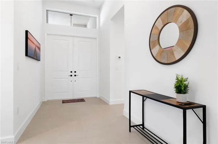 Foyer entrance featuring light tile patterned floors