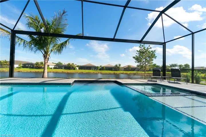 View of swimming pool with a patio area and glass enclosure