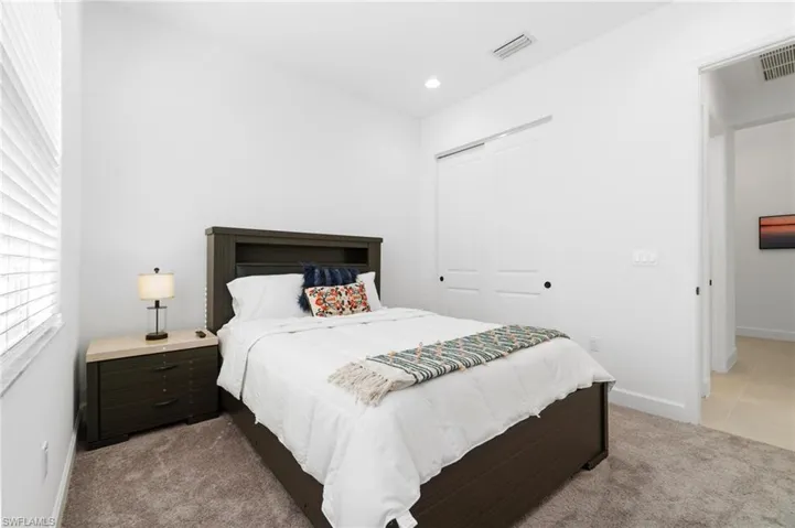 Tiled bedroom with a closet