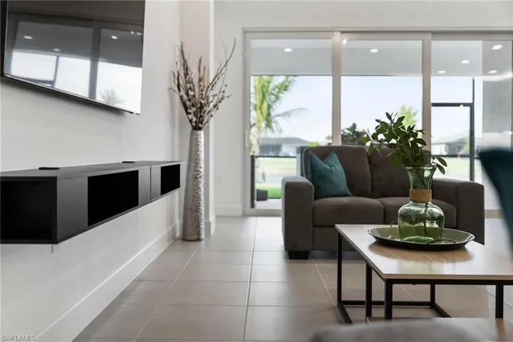 Living room with a wealth of natural light and tile patterned flooring