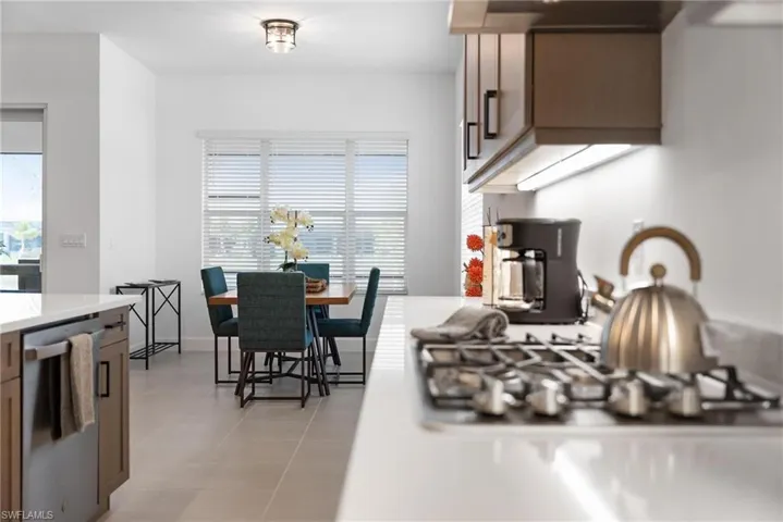 Kitchen with stainless steel dishwasher and light tile patterned floors