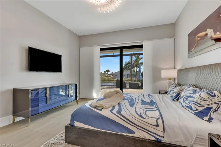 Bedroom with access to outside and wood finished floors