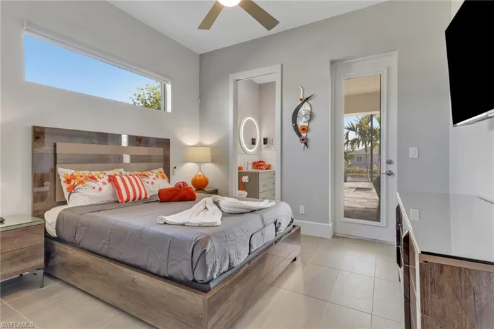 Bedroom with light tile patterned flooring and a ceiling fan