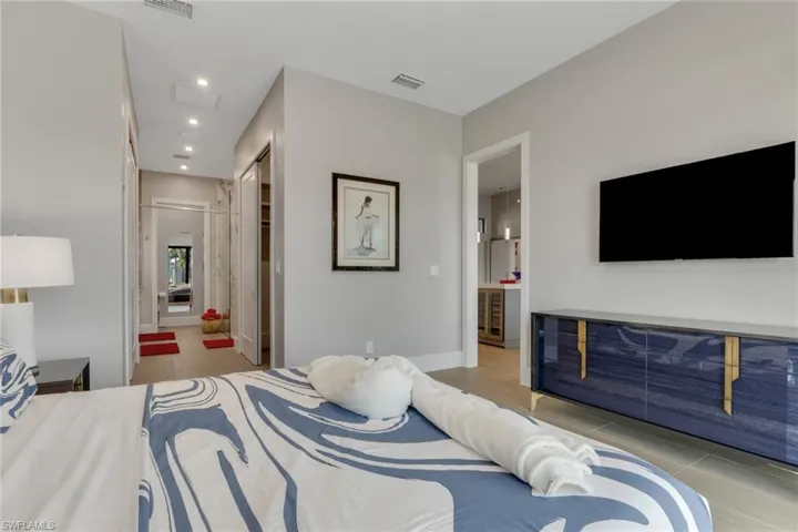 Bedroom featuring connected bathroom, recessed lighting, a closet, and light tile patterned flooring