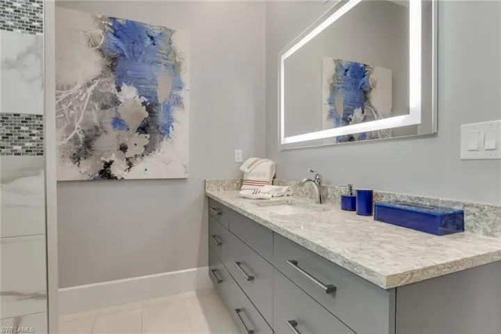 Bathroom with vanity and light tile patterned floors
