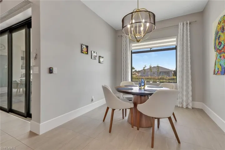 Dining space featuring light tile patterned floors and a chandelier