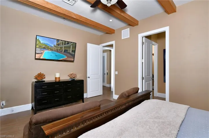 Bathroom with double vanity, a sink, a notable chandelier, and a bath