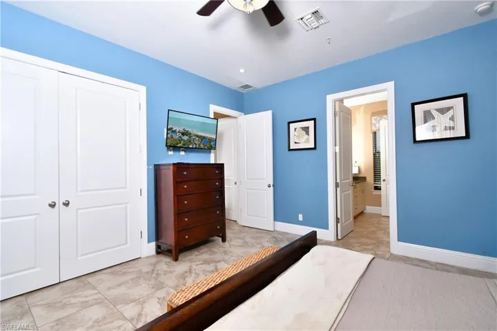 Bathroom with double vanity, a sink, and baseboards