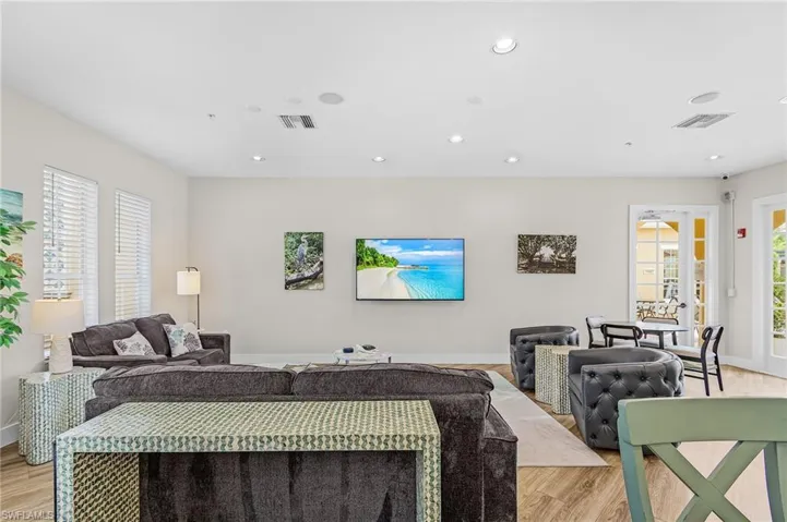 Spacious common area featuring recessed lighting, light wood-finish flooring, and multiple windows with blinds