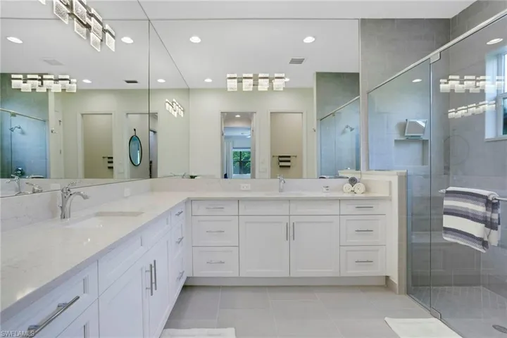Bathroom with vanity, tile patterned flooring, a shower stall, and recessed lighting