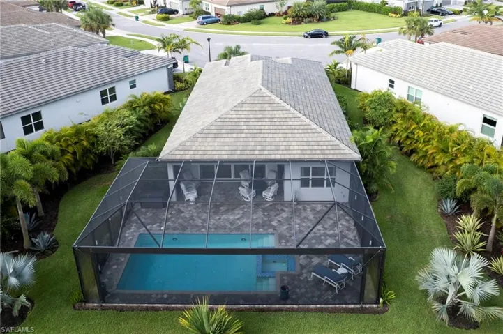 Aerial view of residential area featuring a pool
