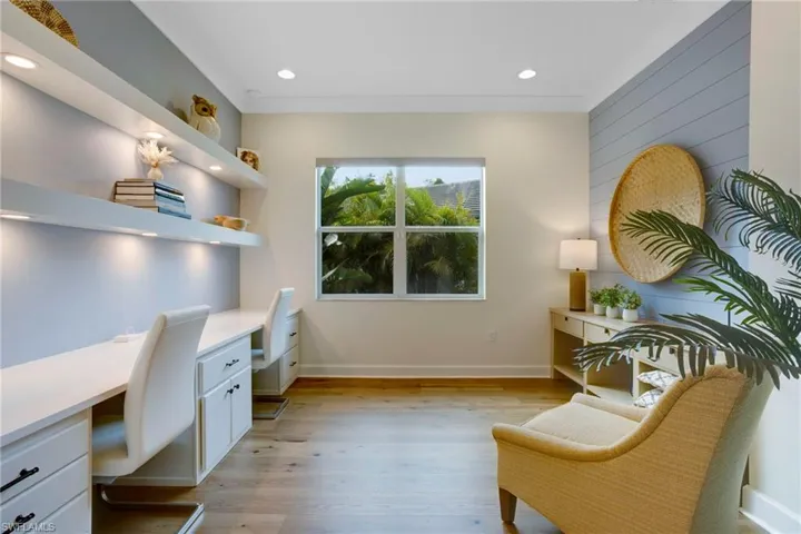 Home office featuring built in desk, recessed lighting, baseboards, and light wood finished floors