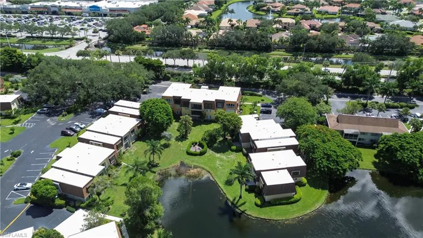 Aerial view of property's location with a nearby body of water and nearby suburban area