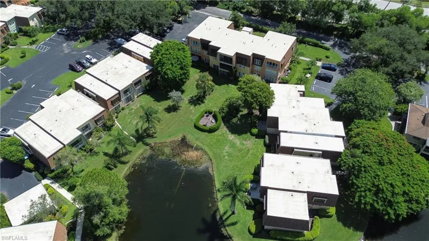 Aerial view of property and surrounding area with a nearby body of water