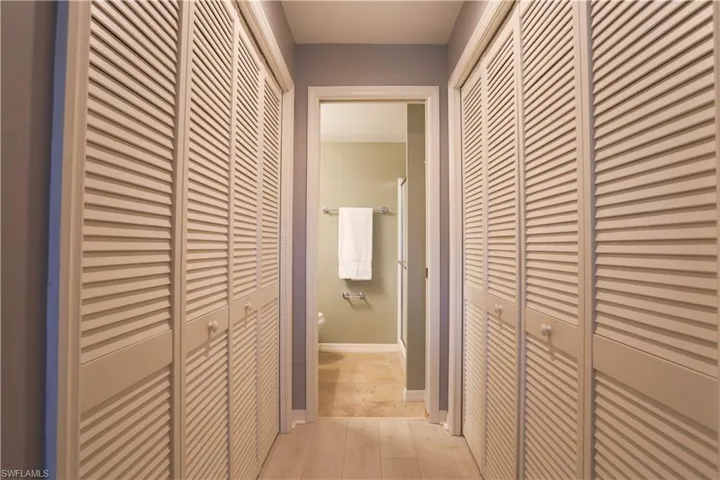 Hallway featuring light wood-type flooring and baseboards