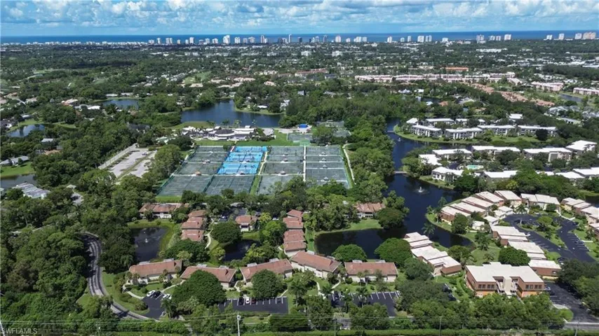 Aerial view of property and surrounding area with nearby urban area and a nearby body of water