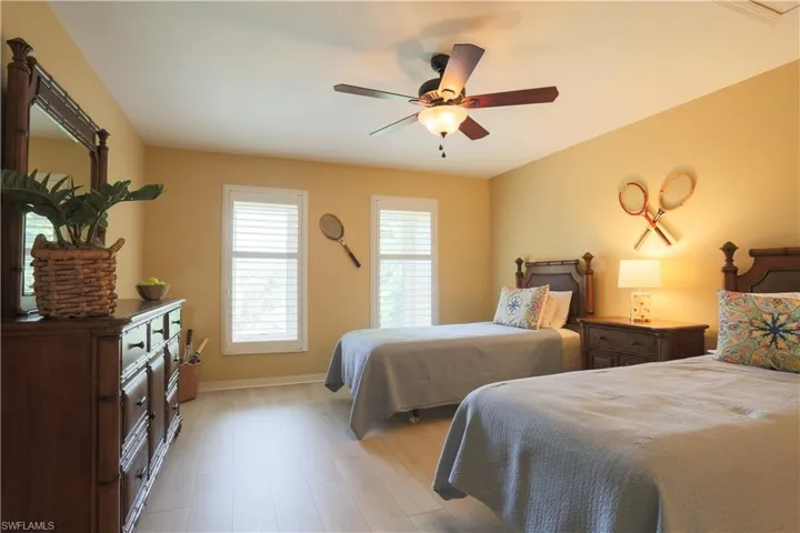 Bedroom with light wood finished floors and a ceiling fan