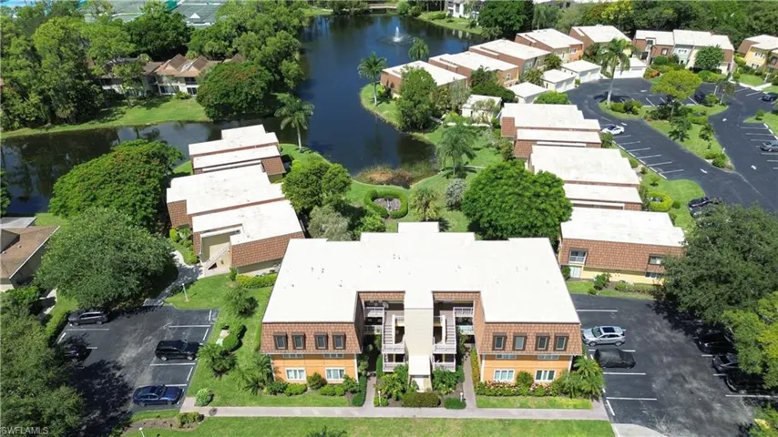 Aerial view of residential area featuring a nearby body of water