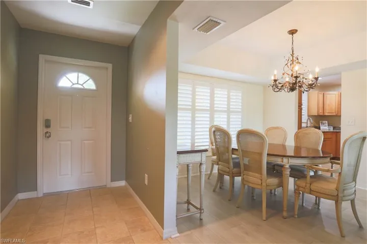 Foyer with a chandelier and light tile patterned floors