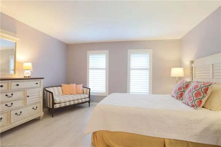 Bedroom with light wood finished floors and baseboards