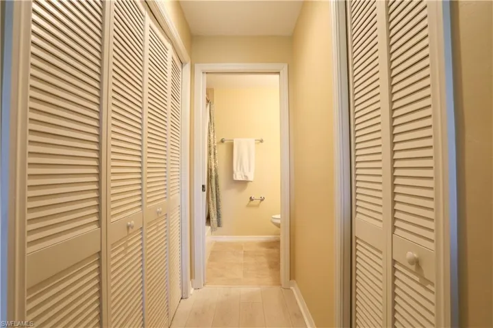 Corridor with baseboards and light wood finished floors