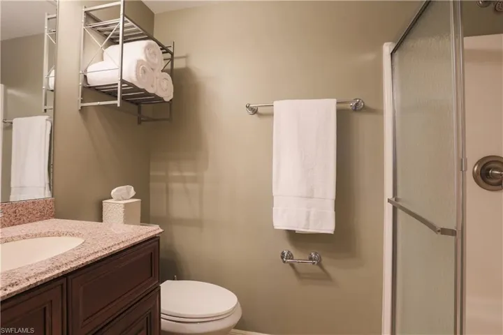 Bathroom with a shower stall and vanity