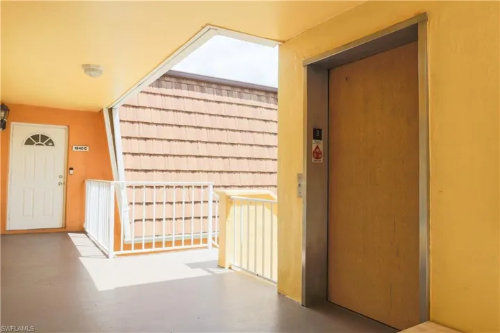 Hallway with elevator and finished concrete flooring
