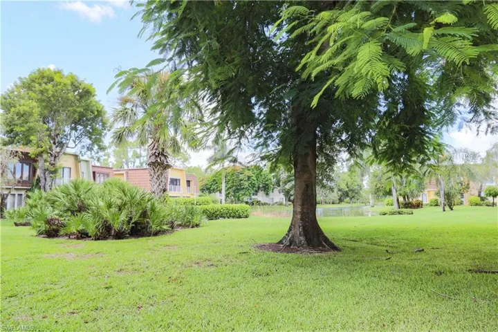 View of grassy yard with a water view