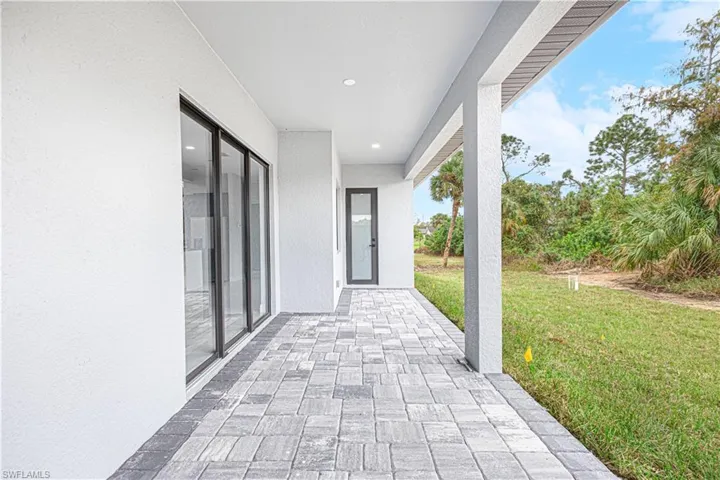 Spacious outdoor patio with paver flooring, providing an inviting space for relaxation
