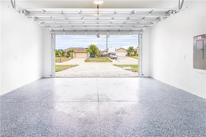 The garage features a coated floor and white walls