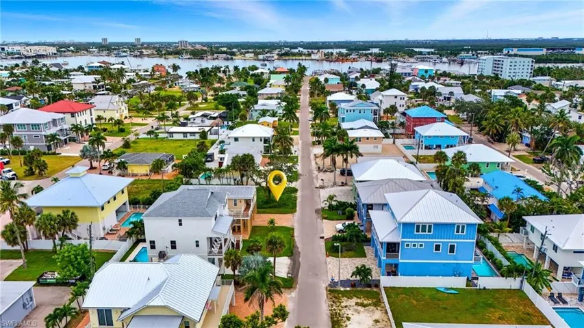 Aerial perspective of suburban area featuring a nearby body of water - Virtually Edited Image