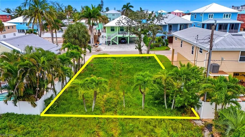 Aerial view of residential area with property parcel outlined - Virtually Edited Image